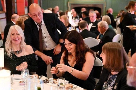 Yorkshire Wedding Magician Adrian Salamon Performing A Magic Trick For A Laughing Bride And Groom During Their Reception. - Hospitium, York