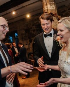 Wedding Magician Adrian Salamon Performing Close-Up Card Magic For A Bride And Groom During Their Reception At The Hospitium In York.
